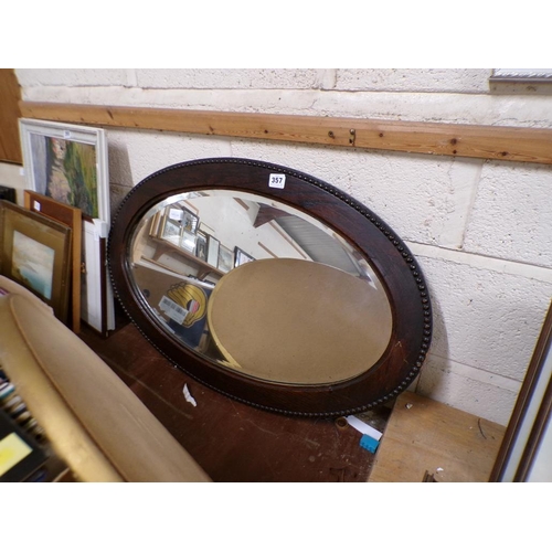 357 - OAK AND GILT FRAMED OVAL MIRRORS