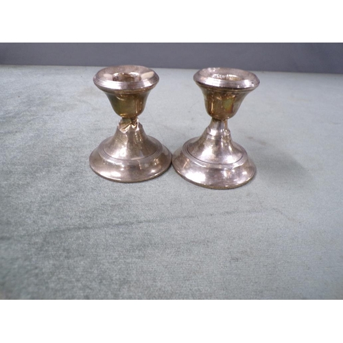 1726 - PAIR OF SQUAT SILVER CASED WEIGHTED CANDLESTICKS