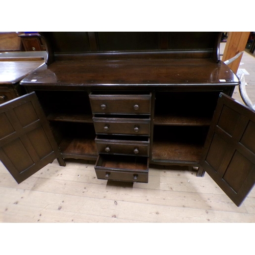 1972 - ERCOL DRESSER WITH FOUR CENTRAL DRAWERS, FLANKED BY CUPBOARD AND PANELLED SHELF BACK - 147 x 170 cms