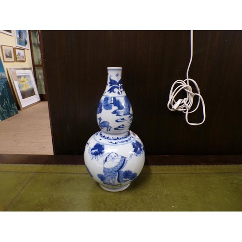 1900 - ORIENTAL BLUE AND WHITE DOUBLE GOURD VASE, 30cms H