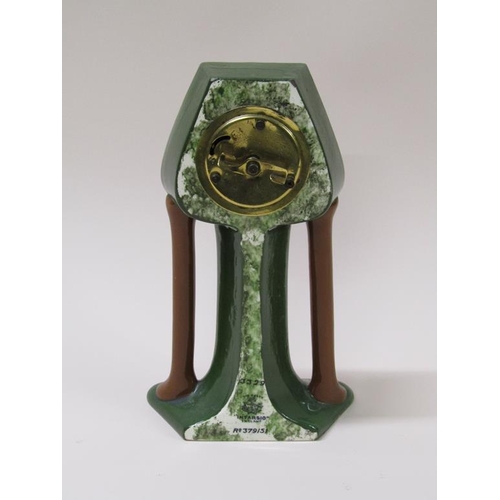 17 - An early 20c mantel clock in an 'Intarsio' Art Nouveau inspired pottery case.  The green glazed case... 