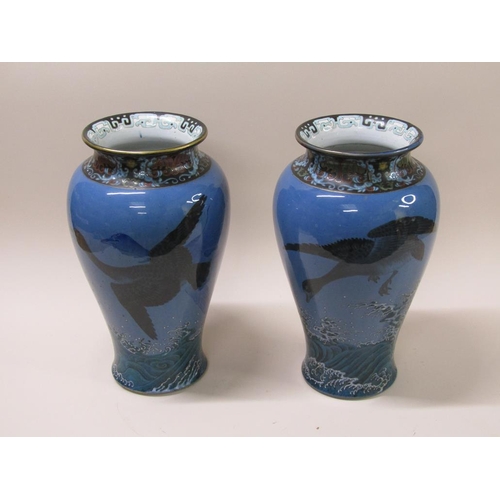 180 - A pair of 19c Japanese Meiji period porcelain vases, painted with geese flying over waves, each with... 