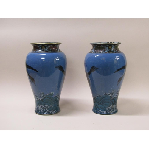 180 - A pair of 19c Japanese Meiji period porcelain vases, painted with geese flying over waves, each with... 