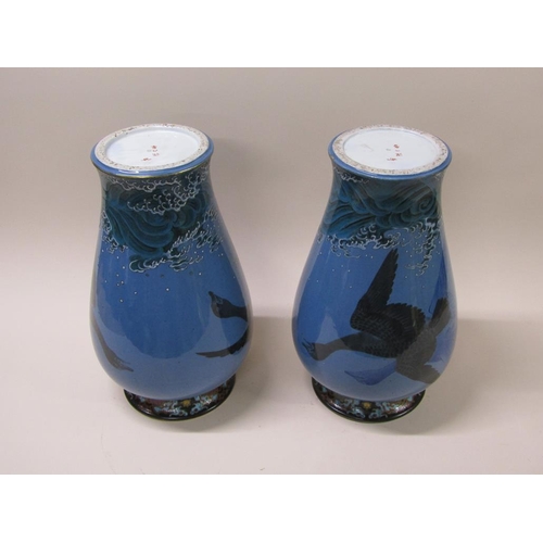 180 - A pair of 19c Japanese Meiji period porcelain vases, painted with geese flying over waves, each with... 