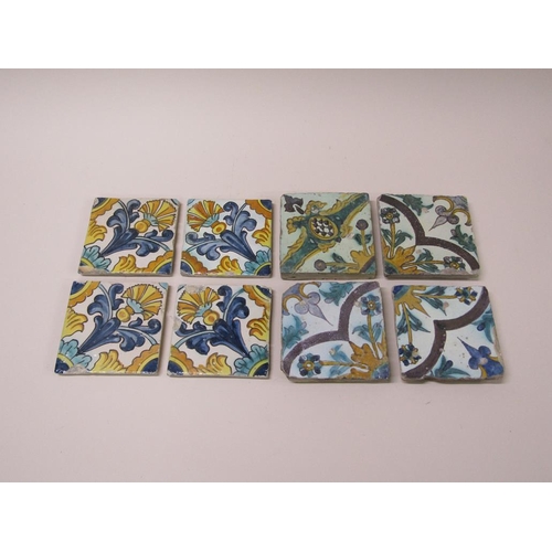 185 - Two sets of four Spanish polychrome tiles of leaf and floral design, principally glazed in yellow gr... 