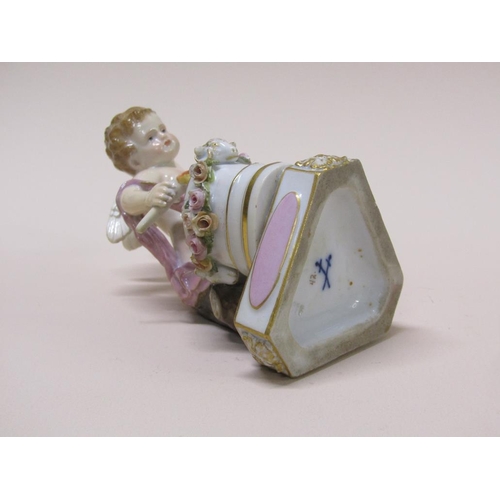 195 - A 19c Meissen porcelain figure of a cupid forging hearts, raised on a rectangular base, titled 'Je l... 