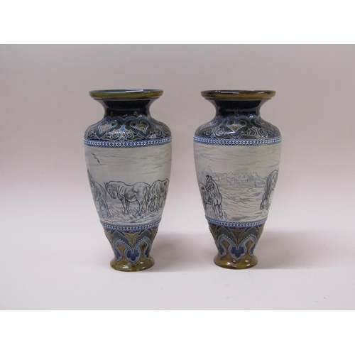 212 - A pair of Doulton Lambeth Hannah Barlow stoneware vases with horse and foal frieze within foliate in... 