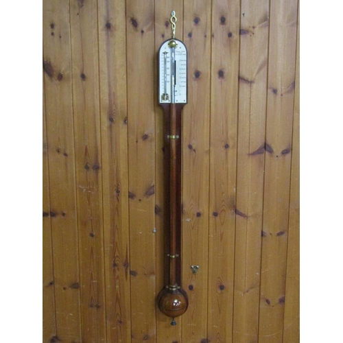 36 - A mid 19c mahogany cistern barometer signed Thos. Jones & Sons, 62 Charing Cross.  The round top cas... 