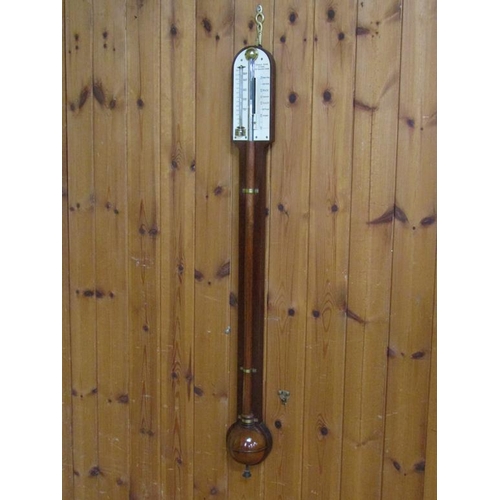 36 - A mid 19c mahogany cistern barometer signed Thos. Jones & Sons, 62 Charing Cross.  The round top cas... 