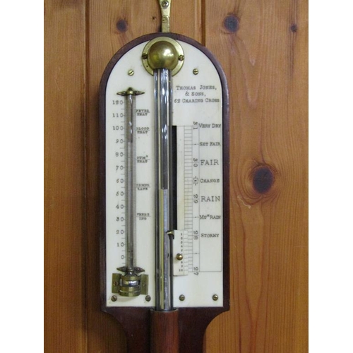 36 - A mid 19c mahogany cistern barometer signed Thos. Jones & Sons, 62 Charing Cross.  The round top cas... 