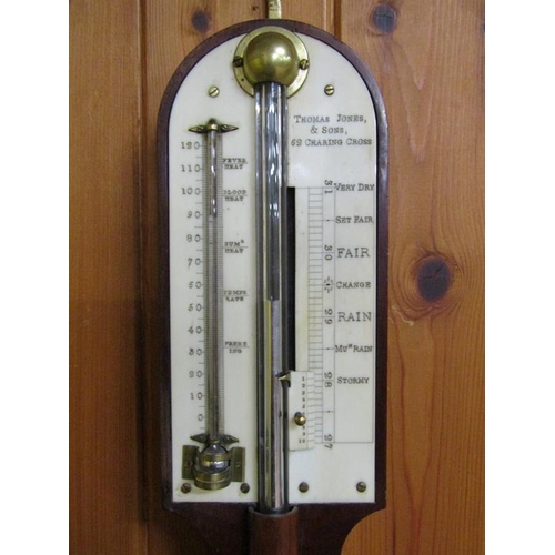 36 - A mid 19c mahogany cistern barometer signed Thos. Jones & Sons, 62 Charing Cross.  The round top cas... 