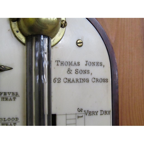 36 - A mid 19c mahogany cistern barometer signed Thos. Jones & Sons, 62 Charing Cross.  The round top cas... 