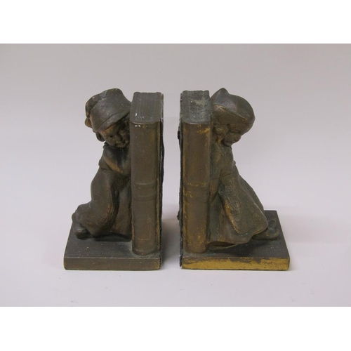 65 - A pair of early 20c gilded plaster bookends, the bookends supported by a young Dutch girl and a sail... 