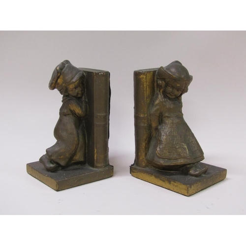 65 - A pair of early 20c gilded plaster bookends, the bookends supported by a young Dutch girl and a sail... 