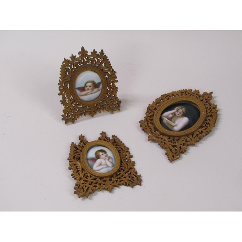 66 - Three 19c oval porcelain plaques, two of cherubs, 6cm x 5cm, and one of a lady reading a book, 8cm x... 