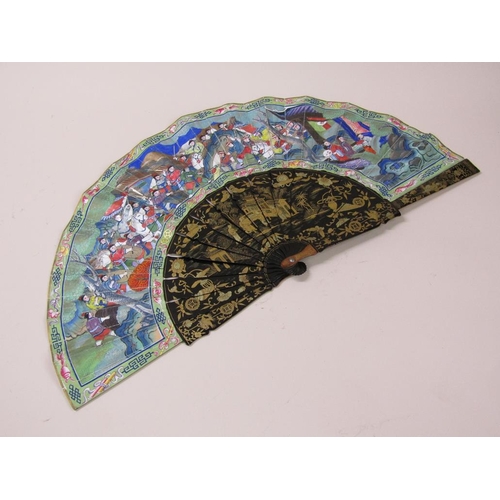 68 - A Japanese Meiji period hand fan with black lacquered sticks, gilt chinoiserie painted and having pa... 