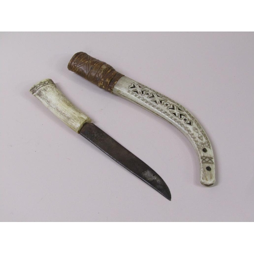 12 - A late 19c/early 20c  dagger with bone handle and sheath, the sheath engraved with reindeers and a s... 