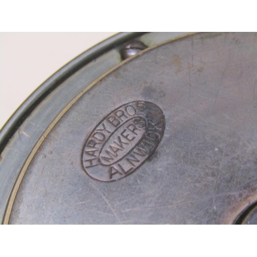 13 - A Hardy Bros of Alnwick fly fishing reel, the trademark incised, 10.5cm diam.