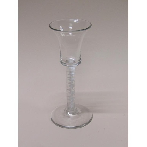 153 - An 18c wine glass with a bell bowl on an opaque white twist stem with a domed circular foot, 15cm h.