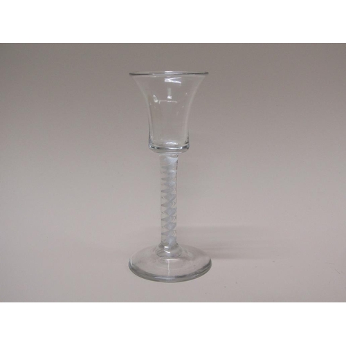 153 - An 18c wine glass with a bell bowl on an opaque white twist stem with a domed circular foot, 15cm h.