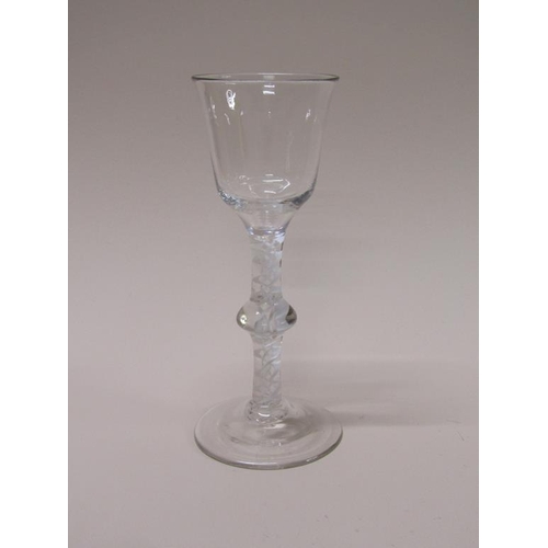 155 - An 18c wine glass with a bell shaped bowl on a double opaque white twist single knop stem with a sli... 