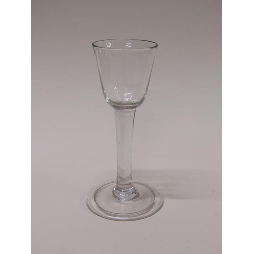 156 - An 18c wine glass with an ogee bowl on a clear stem with a folded circular slightly domed foot, 14cm... 