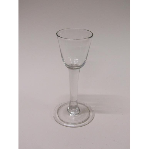 156 - An 18c wine glass with an ogee bowl on a clear stem with a folded circular slightly domed foot, 14cm... 