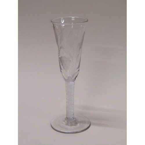 157 - An 18c wine glass with a fluted bowl engraved with wheatear and grapes on an opaque white spiral thr... 