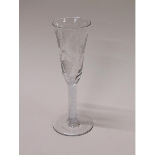 157 - An 18c wine glass with a fluted bowl engraved with wheatear and grapes on an opaque white spiral thr... 