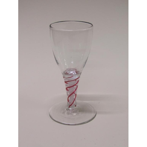 161 - An 18c wine glass with an ovoid bowl on a short tapering stem with alternating red and white spiral ... 