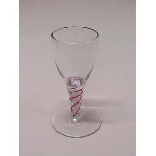 161 - An 18c wine glass with an ovoid bowl on a short tapering stem with alternating red and white spiral ... 