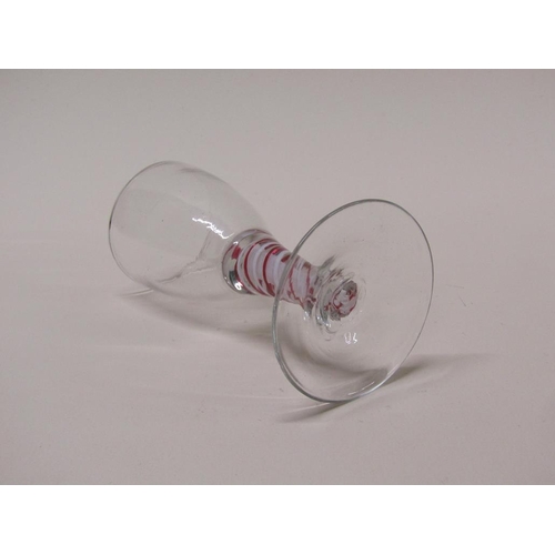 161 - An 18c wine glass with an ovoid bowl on a short tapering stem with alternating red and white spiral ... 