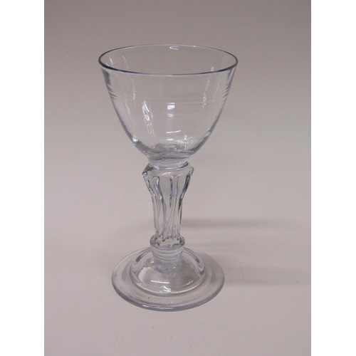 163 - An 18c goblet with a funnel bowl on an eight sided slightly writhen pedestal stem with a domed circu... 