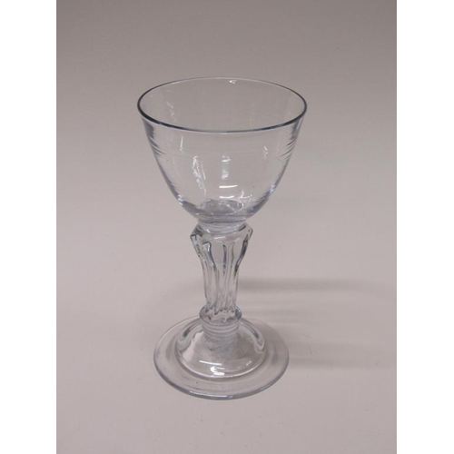 163 - An 18c goblet with a funnel bowl on an eight sided slightly writhen pedestal stem with a domed circu... 