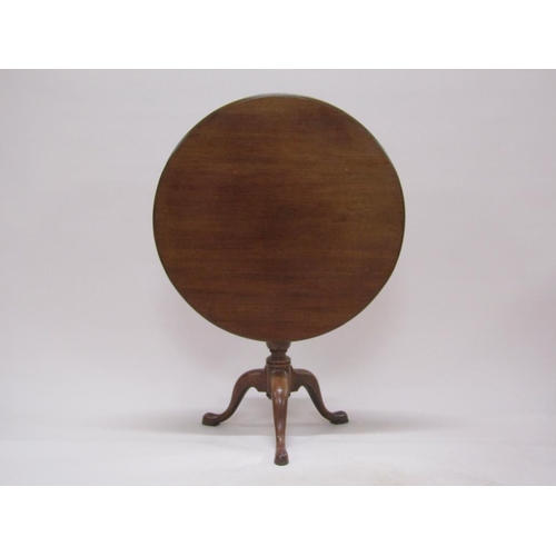 273 - A late Georgian mahogany circular pedestal tilt top table with a baluster carved column raised by th... 