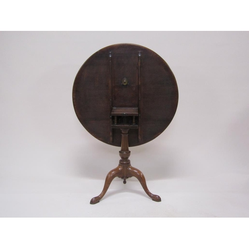 273 - A late Georgian mahogany circular pedestal tilt top table with a baluster carved column raised by th... 