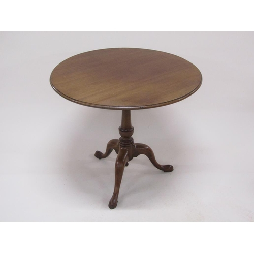 273 - A late Georgian mahogany circular pedestal tilt top table with a baluster carved column raised by th... 