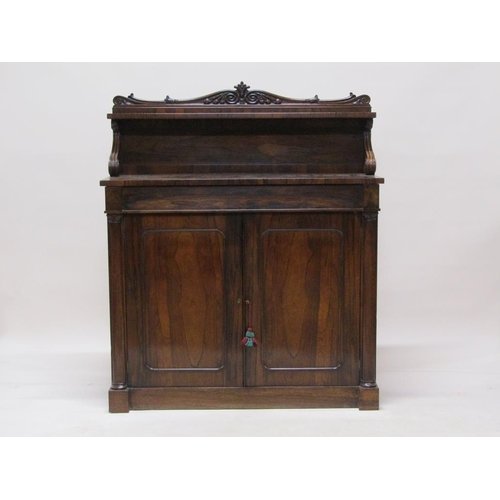 287 - An early 19c rosewood chiffonier with panel back and shelf under a scroll carved pediment, fitted on... 