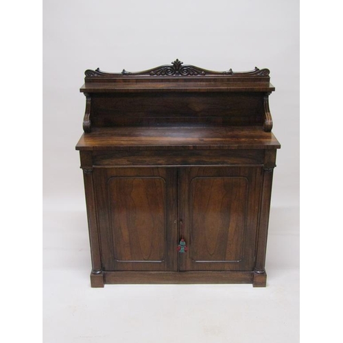 287 - An early 19c rosewood chiffonier with panel back and shelf under a scroll carved pediment, fitted on... 