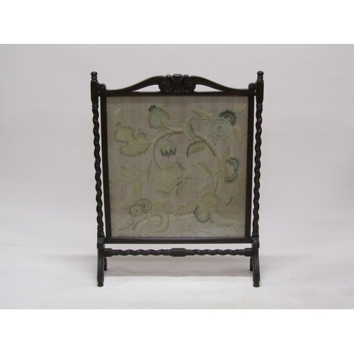 293 - A late 19c/early 20c carved oak twist carved fire screen with a needlework leaf and floral patterned... 