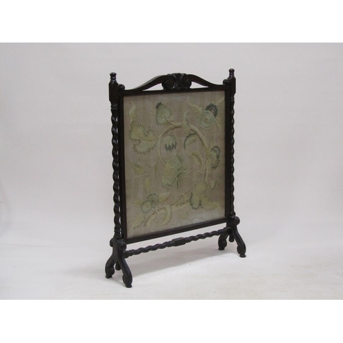 293 - A late 19c/early 20c carved oak twist carved fire screen with a needlework leaf and floral patterned... 