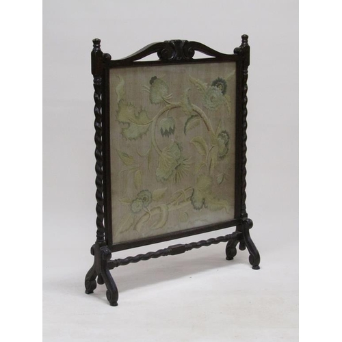 293 - A late 19c/early 20c carved oak twist carved fire screen with a needlework leaf and floral patterned... 