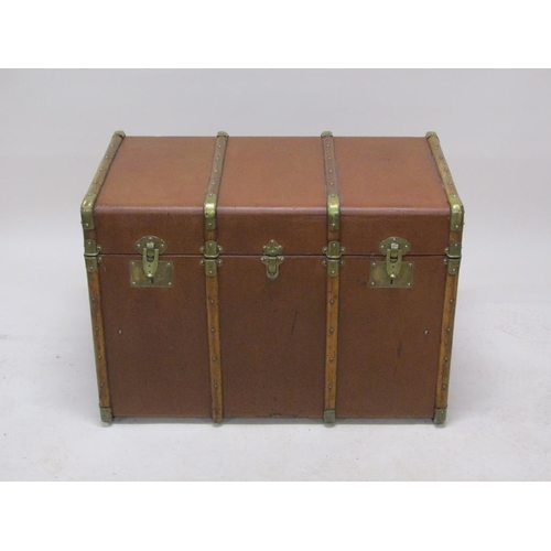 295 - An early 20c brown leatherette travel trunk with wooden rails, brass mounted, the interior fitted wi... 