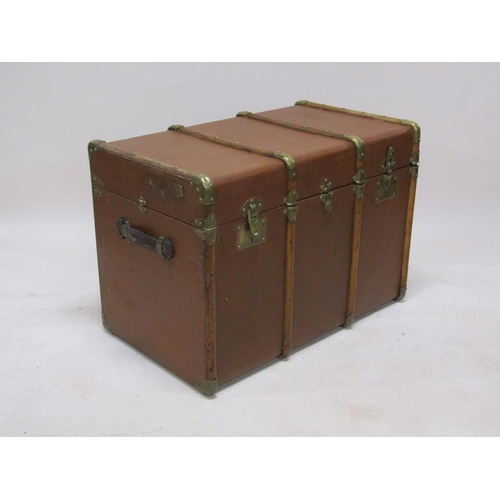 295 - An early 20c brown leatherette travel trunk with wooden rails, brass mounted, the interior fitted wi... 