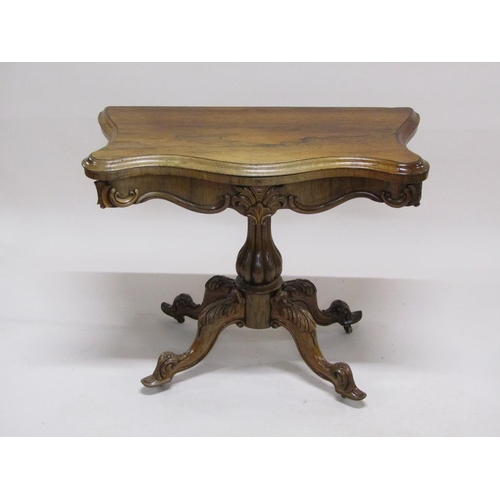 297 - A 19c rosewood pedestal fold over card table, the table top of serpentine form on a lobed baluster c... 