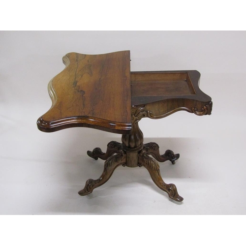 297 - A 19c rosewood pedestal fold over card table, the table top of serpentine form on a lobed baluster c... 