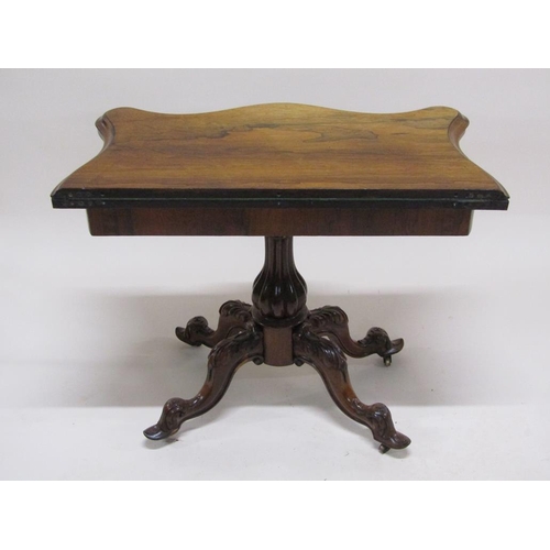 297 - A 19c rosewood pedestal fold over card table, the table top of serpentine form on a lobed baluster c... 