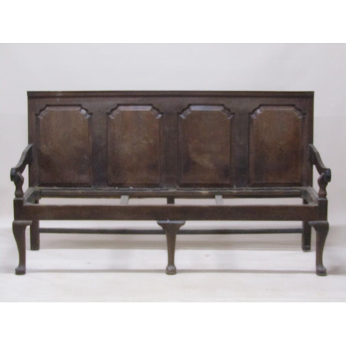 301 - A late 18c/early 19c oak and walnut four panel back settle with scrolling arms, square shaped rear l... 