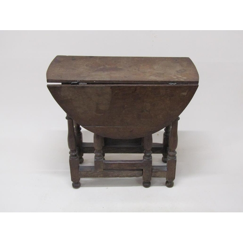 303 - An 18c oak twin flap oval gateleg table, 78cm w, 70cm h.