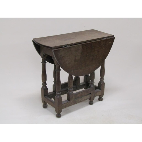 303 - An 18c oak twin flap oval gateleg table, 78cm w, 70cm h.